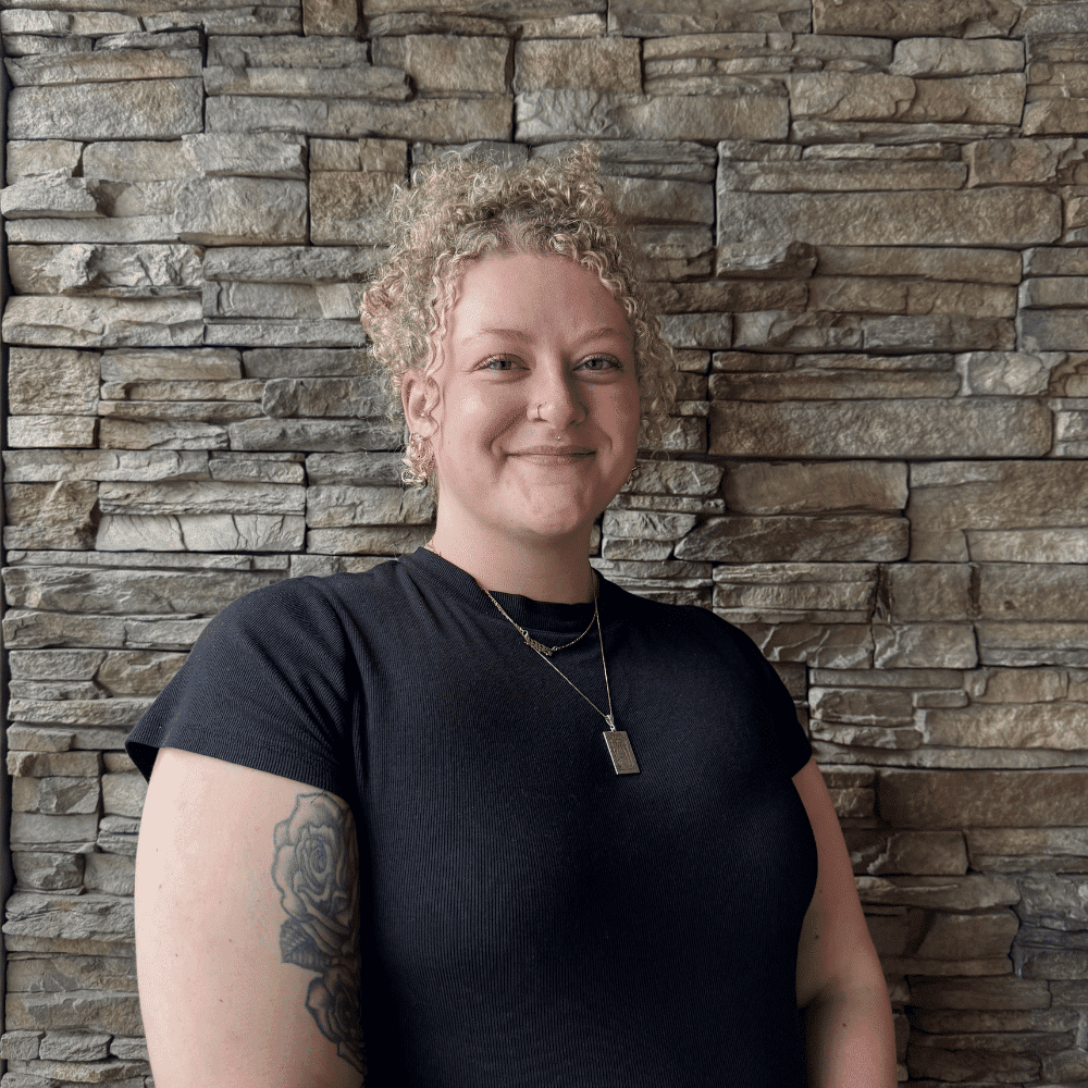 Portrait of Brinley Smith, a professional stylist at Enmoda Salon x Spa, showcasing their expertise and style.
